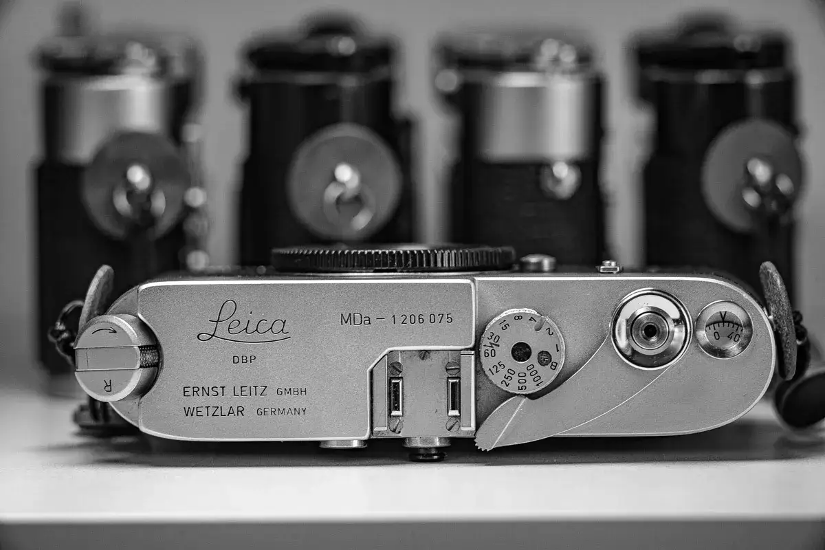 A vintage Leica MDa camera, a classic piece of photographic history, sits in sharp focus.