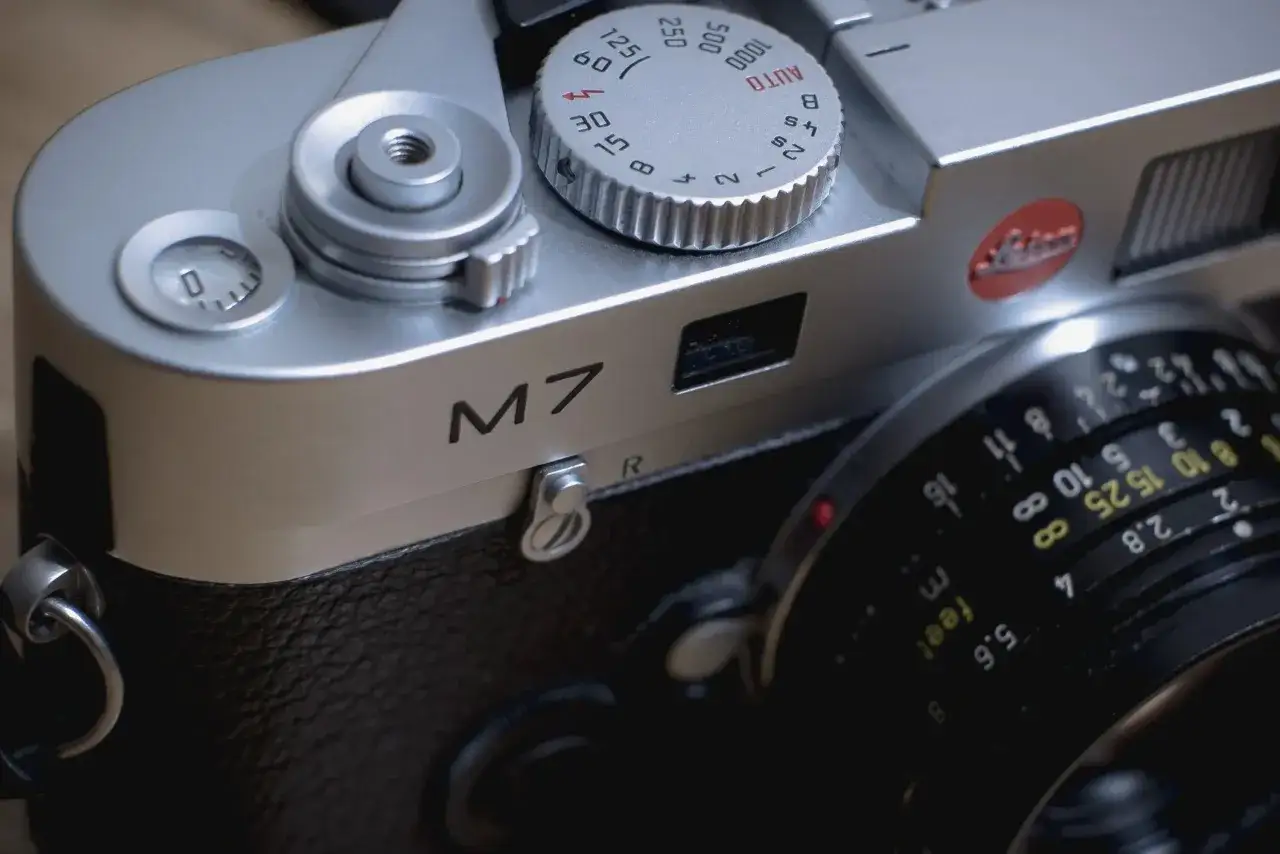 Close-up of a silver Leica M7 camera, ready for a detailed leica m7 review. The lens aperture markings are visible.