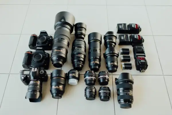 Nikon cameras and lenses laid out, a photographer's dream. Choosing the right camera depends on your needs, from portraits to landscapes.