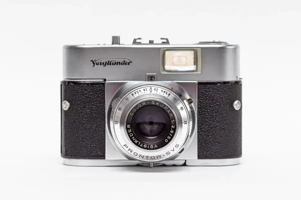 A vintage silver and black Voigtländer camera with a prominent lens and viewfinder.